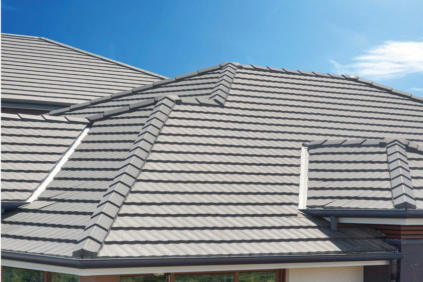 Modern residential roof featuring light gray metal or stone-coated steel tiles laid in horizontal rows, designed for durability as Billings Hail Proof Roofing, a specialty of Wegner Roofing & Solar.