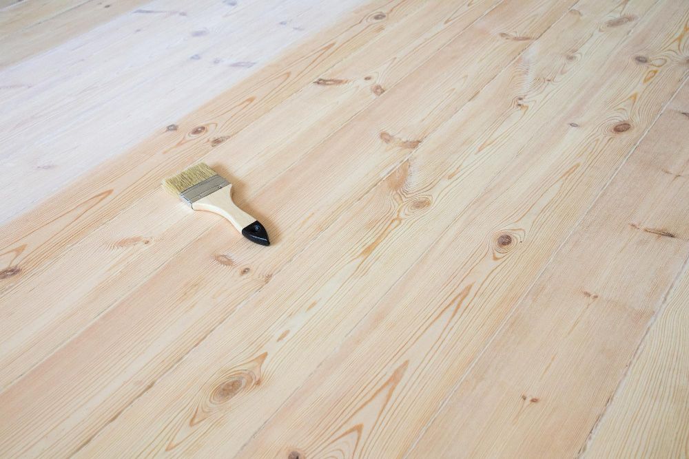 Sanding process during Burlington Hardwood Floor Refinishing to prepare wooden surfaces for staining and sealing.