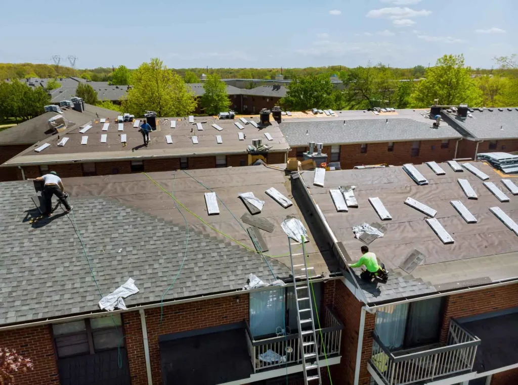 The Pro24 Contracting, Inc. crew at work on a large-scale Ramsey MN Roof Replacement for a multi-unit residential building, showcasing their team's expertise and efficiency.