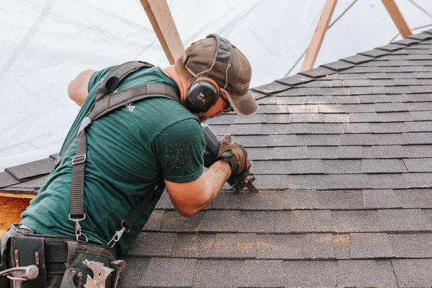 Nashville TN Roofing Company, Burish Builder TN. A close-up shot of a roofer installing shingles on a roof.