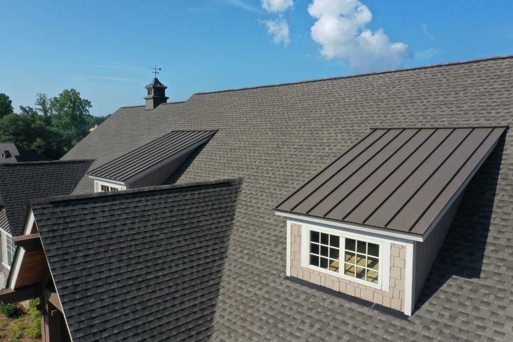 Professional asphalt shingle and metal roof installation on a residential home by Carver MN Roofing Services.