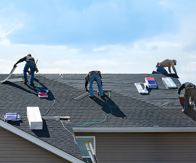 FL Pro Roofing & Solar crew, one of the top North Palm Beach Residential Roofing Companies, laying underlayment on a roof.