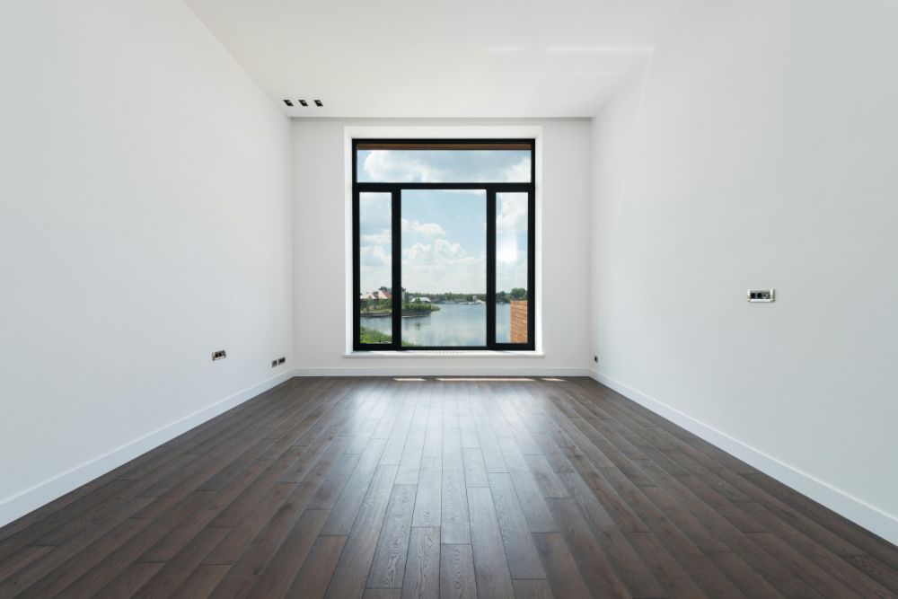 Freshly finished dark wood flooring in a bright, modern room showcasing the results of an Oak Ridge Hardwood Clean and Buff service.