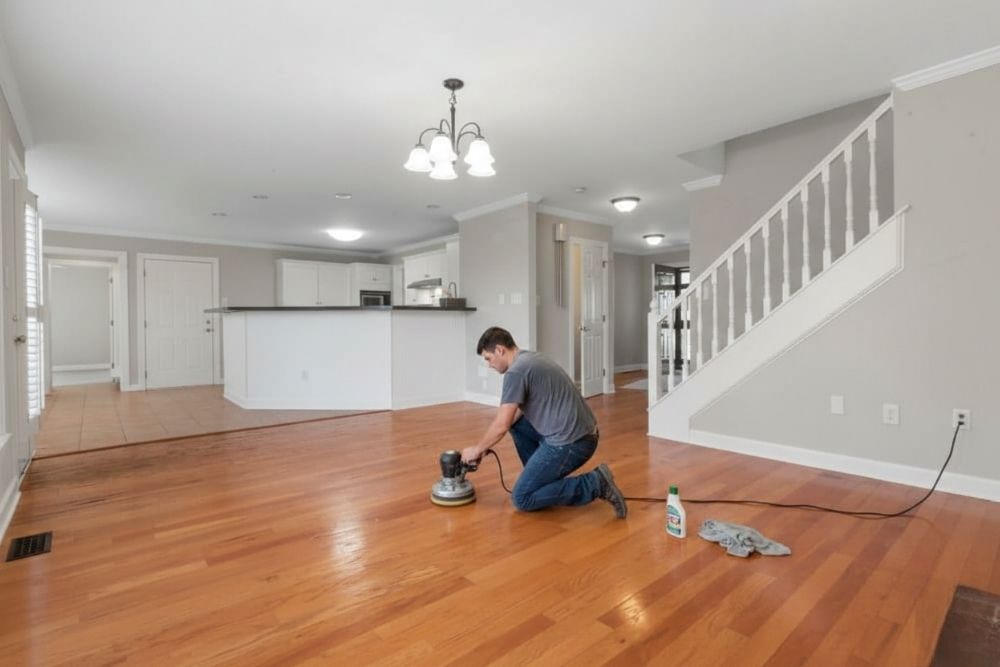 Professional technician providing Clean and Buff Mill Creek services on hardwood floors.