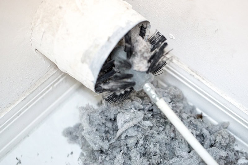 Dryer Vent Cleaning Colorado Springs, CO by HP Duct Cleaning using a professional brush to remove heavy lint buildup.