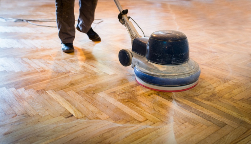 Hardwood Clean Buff Pineville NC by Good House Floor Care: Professional buffing machine reviving a wood herringbone floor.
