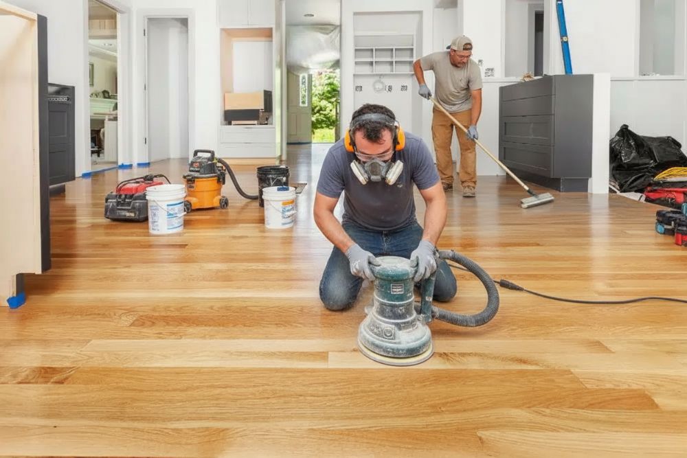Professional team performing hardwood floor refinishing Mercer Island in a residential home.