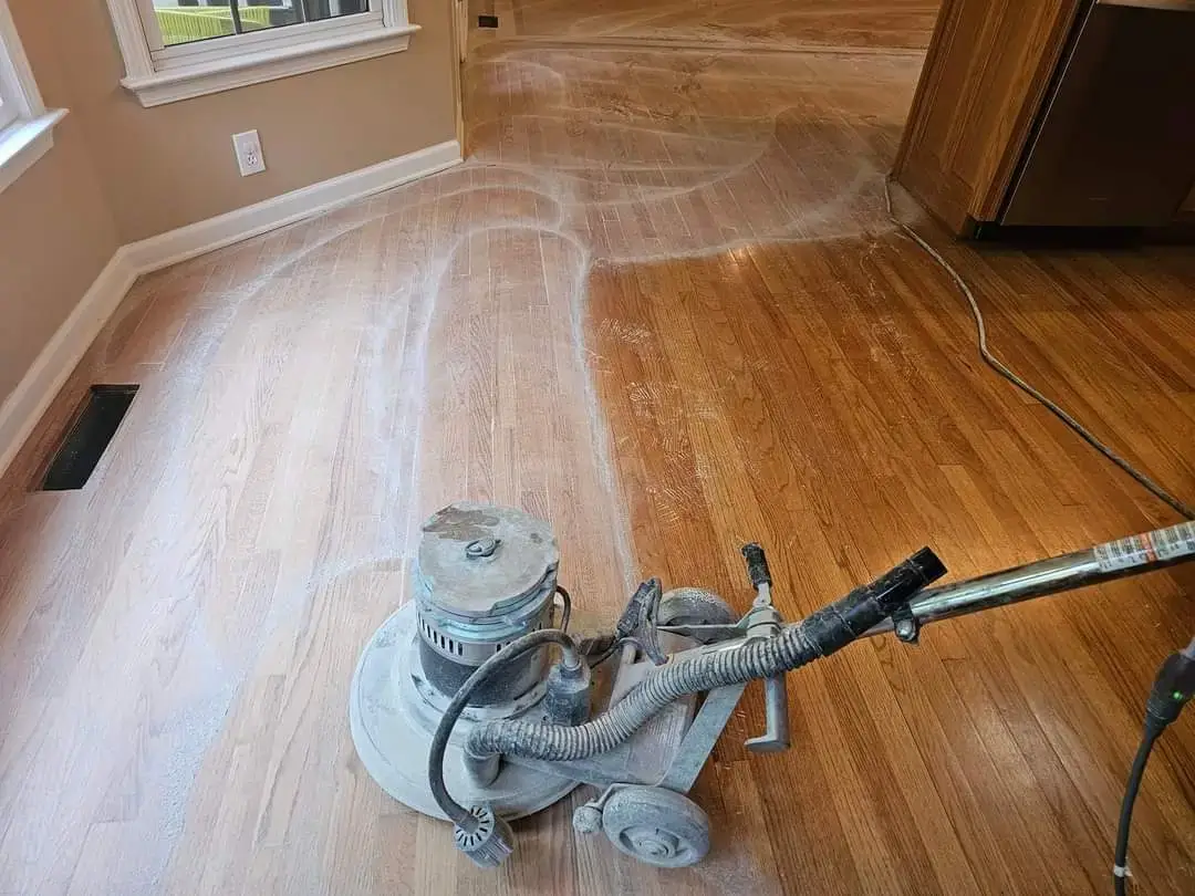 Hardwood Floor Wax Removal Ballantyne NC by Good House Floor Care: Industrial buffer stripping old wax from wood planks.