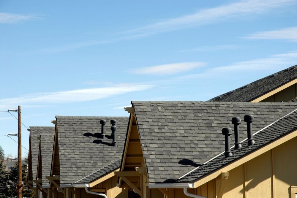 Professional asphalt shingle installation for a Roseburg residential roof repair project on a multi-unit home.
