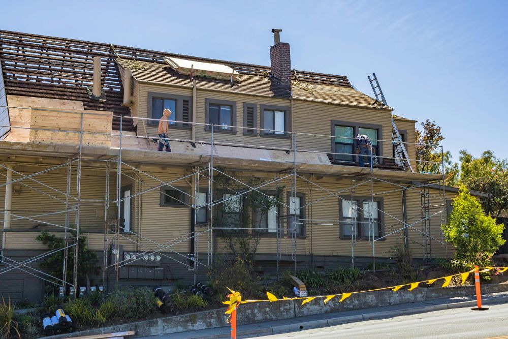 Professional Commercial Roofing Contractors Washington MN worker wearing safety harness on a tile roof.