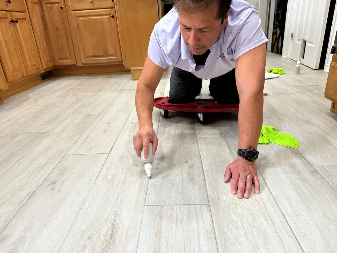Hardwood Floor Repair Montclair VA by Spotless Carpet Cleaning & Hardwood Floor Care: Pro filling gaps in wood-look flooring.