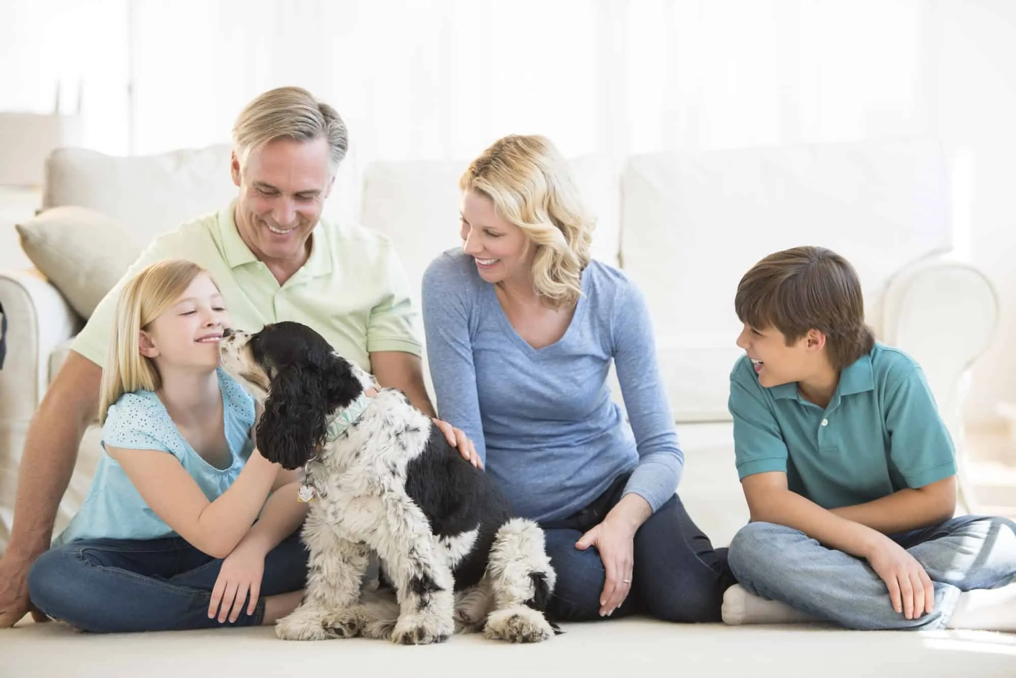 Family on clean carpet via Pet Stain and Odor Removal Colorado Springs CO by Premier Carpet Cleaning.