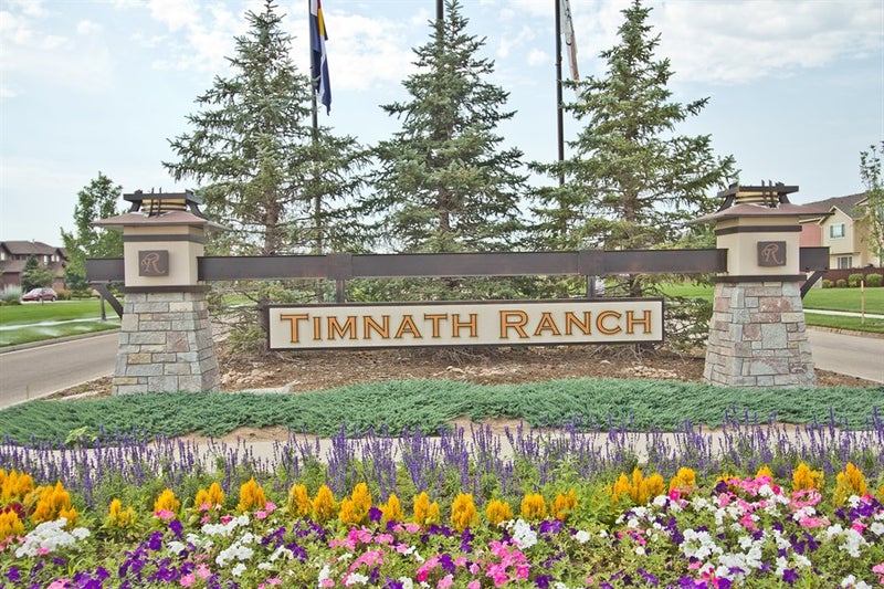 Local SEO Timnath Ranch by Top Click Joe Inc: A stone monument sign for the Timnath Ranch community with colorful flowers.