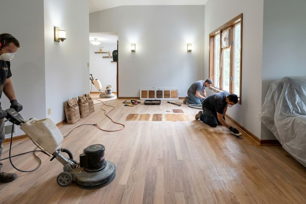 Professional crew performing Hardwood Floor Refinishing Issaquah WA, with professional sanders and masks.