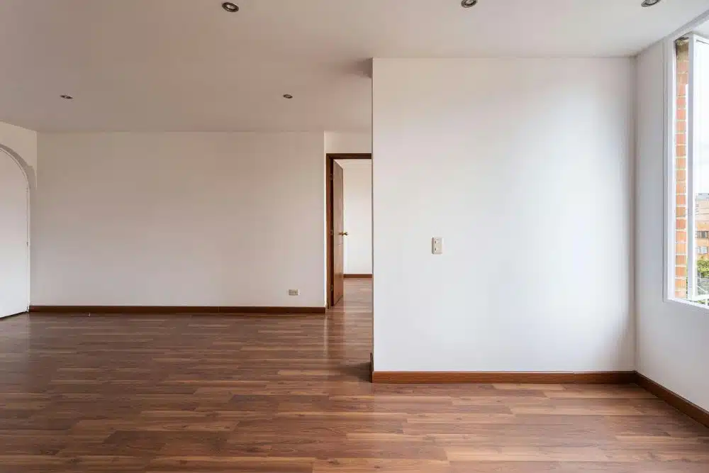 High-quality hardwood floor refinishing Redmond WA in a bright, modern living room with white walls.