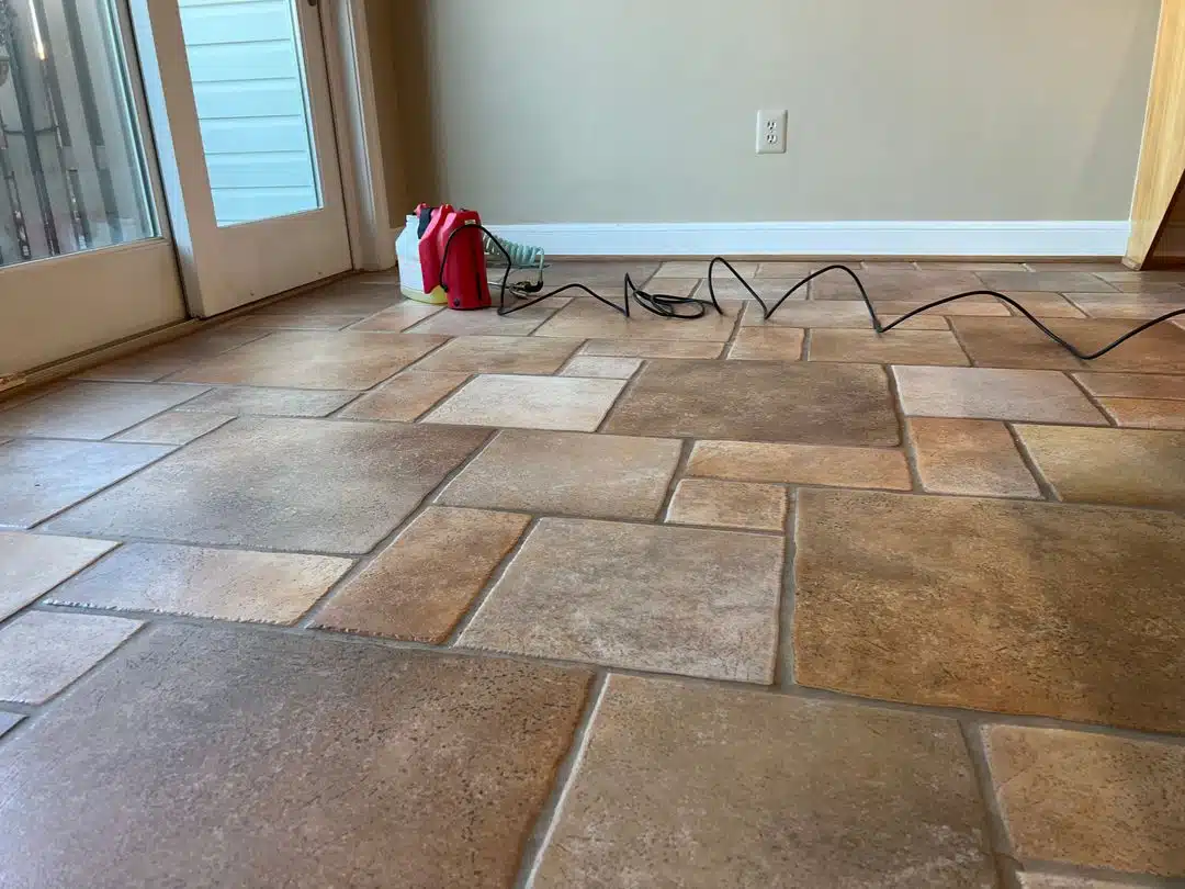 Equipment on brown floor for Tile & Grout Cleaning Alexandria VA by Spotless Carpet Cleaning & Hardwood Floor Care.