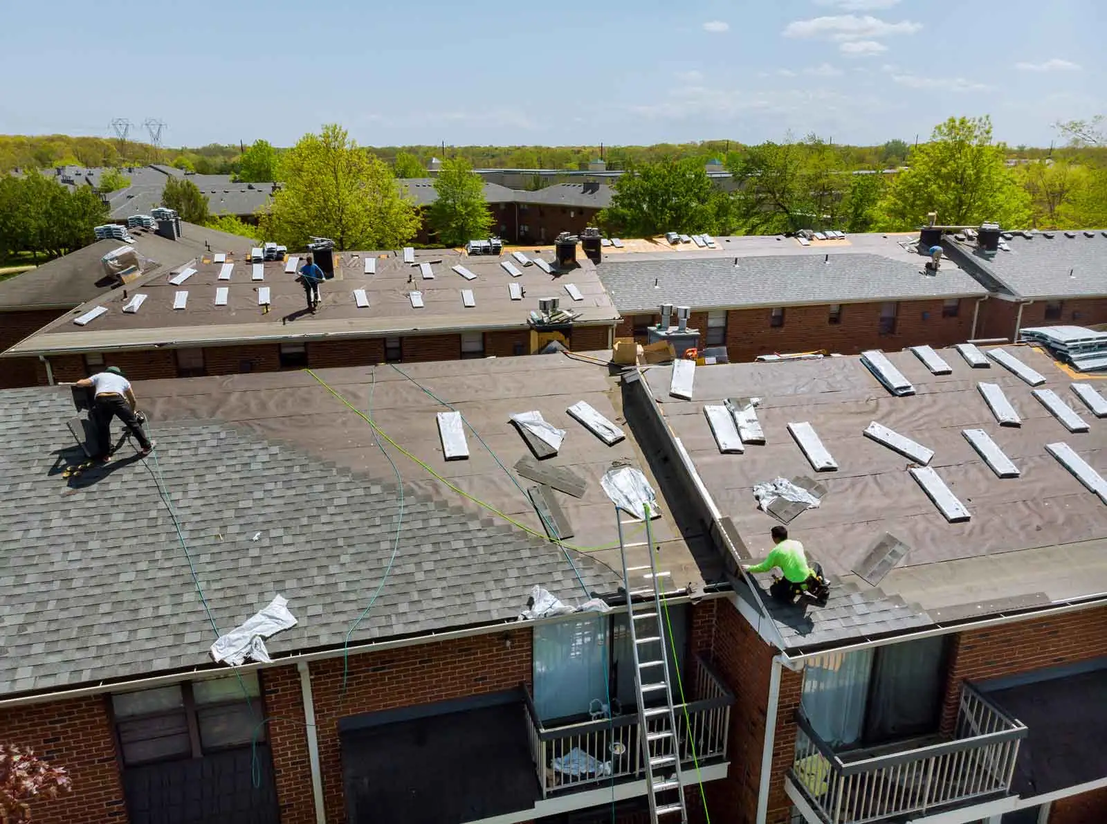 Wegner Roofing & Solar crew installing new shingles on a multi-unit building. Best Roofers Nashville TN in action.