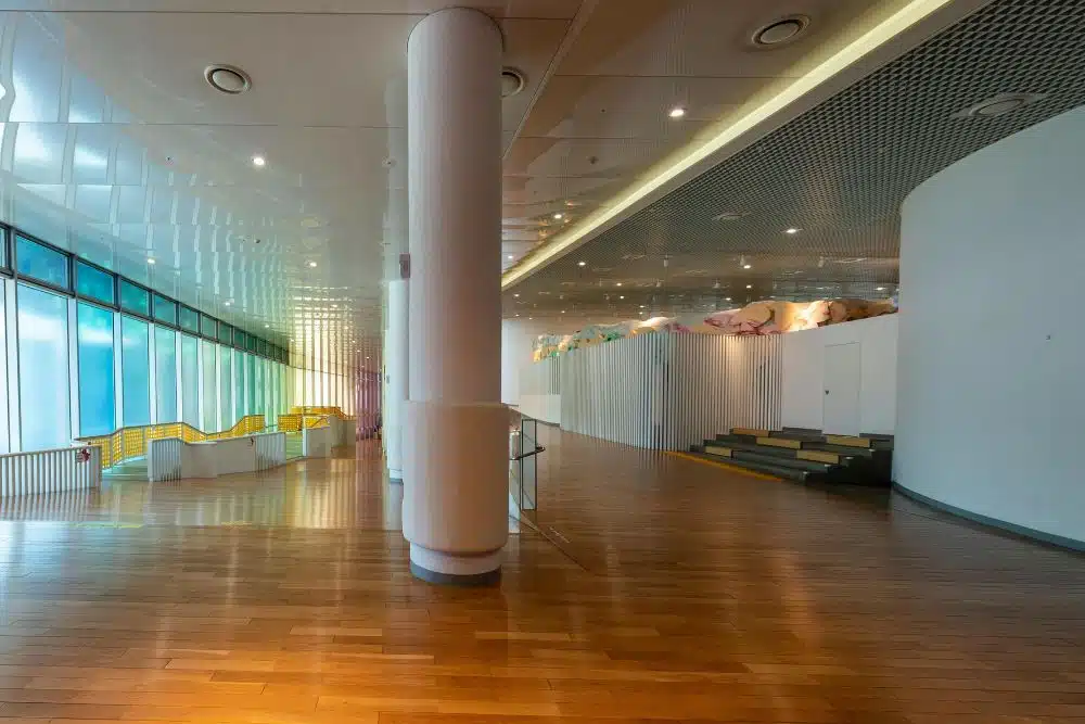 A wide-angle view of a professional Chamblee, GA commercial flooring installation featuring high-gloss hardwood in a modern facility.