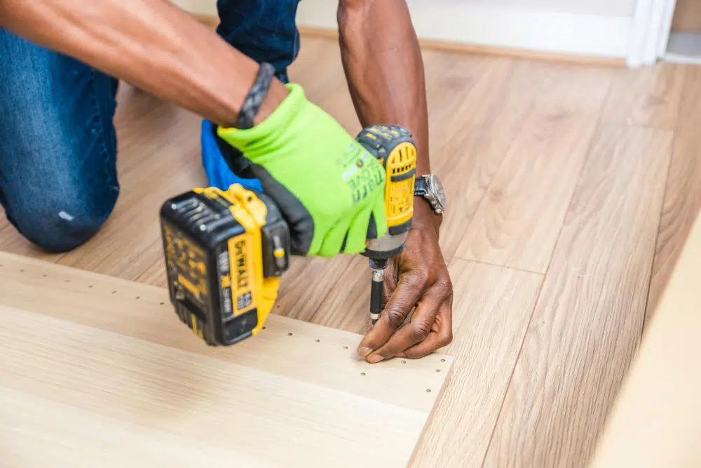 Professional contractor performing Chamblee, GA hardwood floor installation using precision tools.