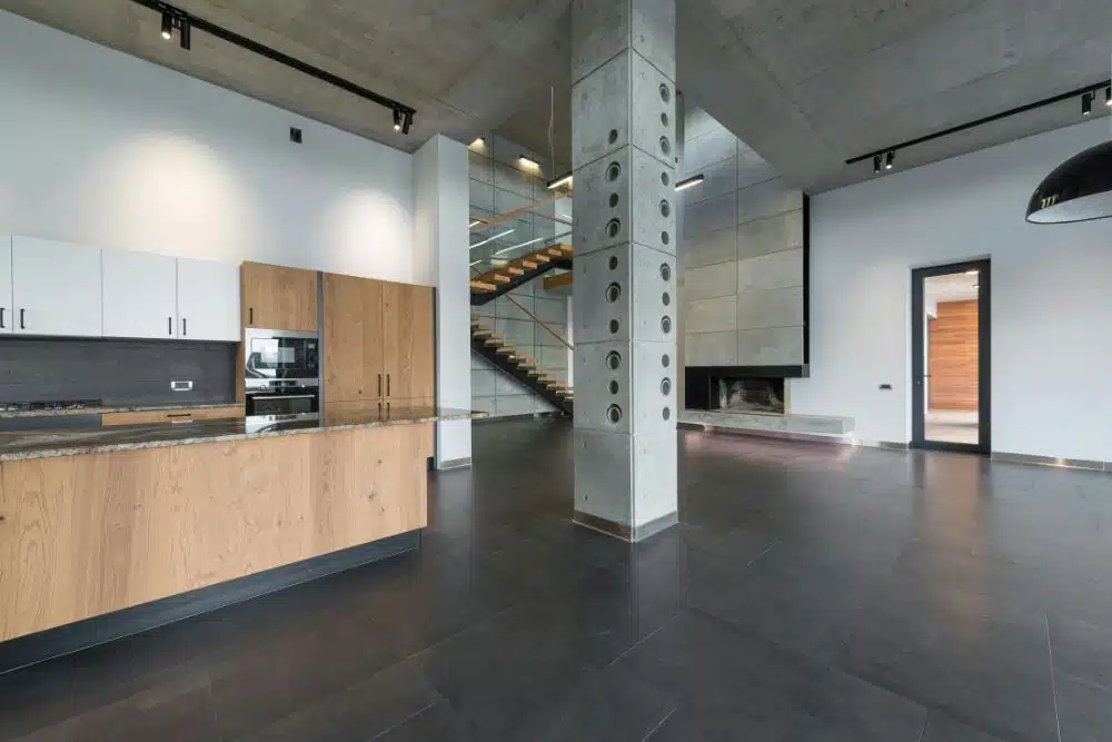 A wide-angle view of a modern industrial loft with dark flooring, serviced by Chamblee, GA Hardwood Floor Refinishing.