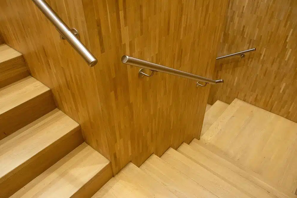 Completed modern wood staircase and metal handrail system from a top-down view in a Chamblee, GA home.