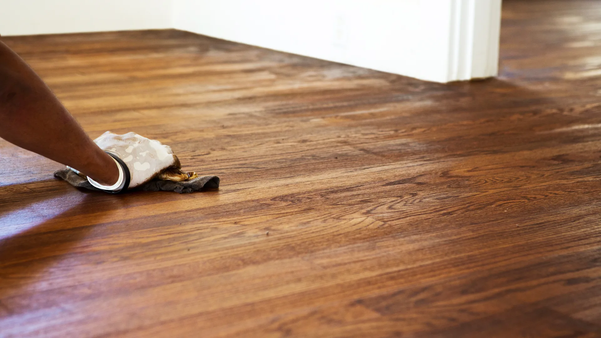 Hardwood Floor Refinishing Monroe NC by Good House Floor Care: A professional hand-staining rich wood planks to perfection.