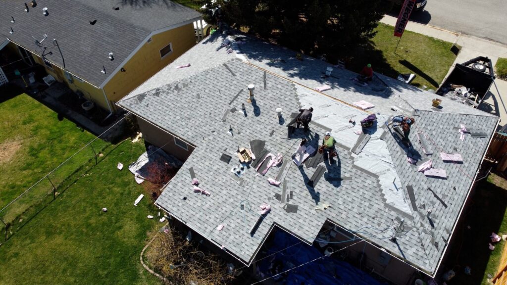 Aerial view of Roofing Companies Nashville TN by Wegner Roofing & Solar performing a residential roof replacement with shingles.