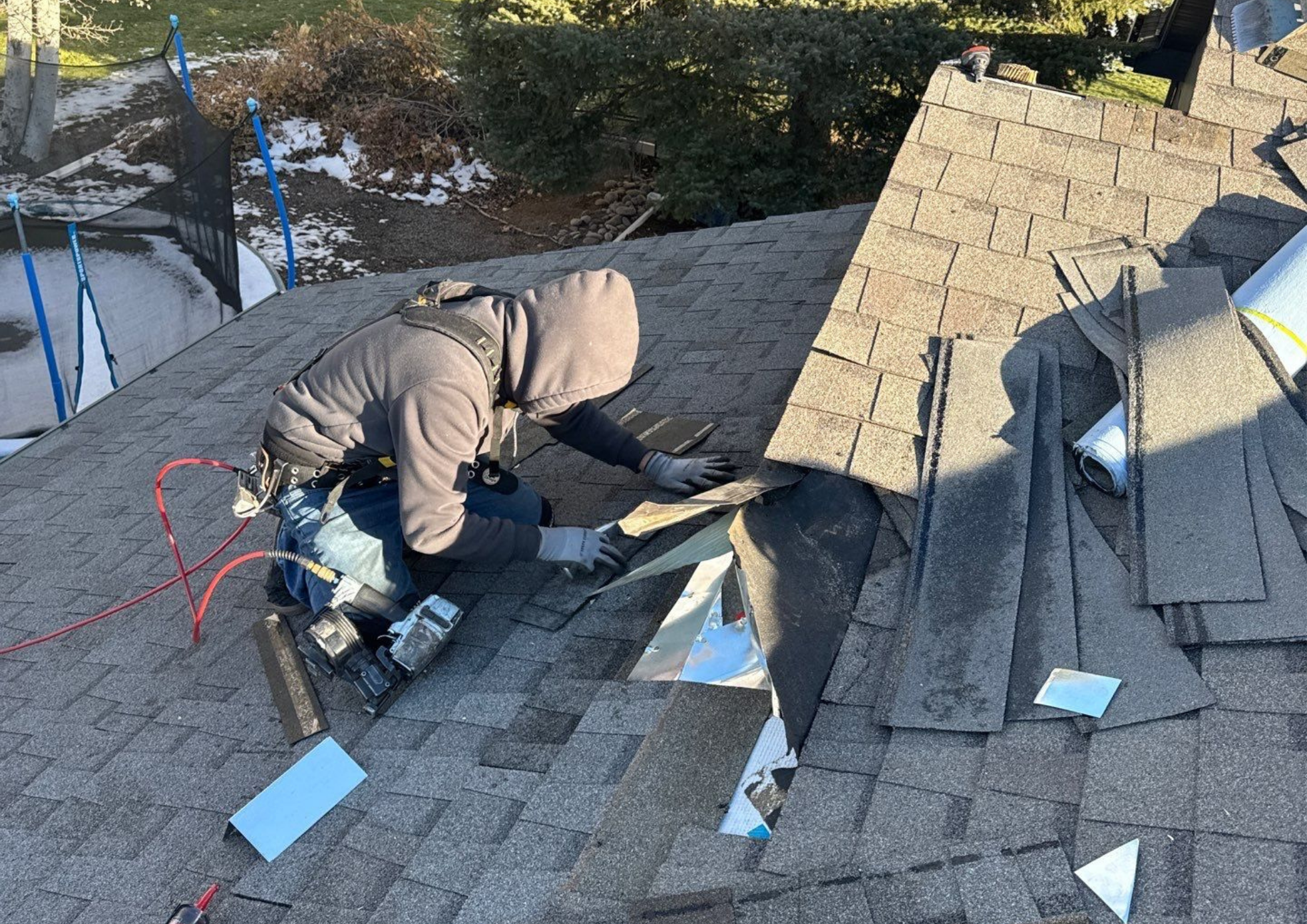 Expert Roofing Contractor Franklin TN Wegner Roofing & Solar technician repairing shingles and flashing on a residential home.