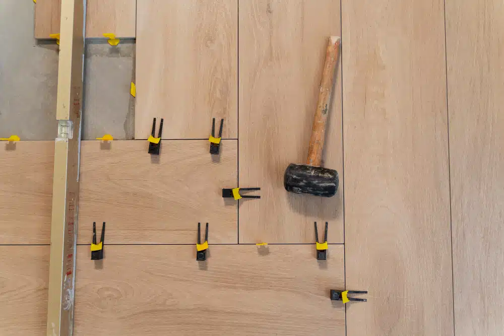Professional Canton, GA LVP installation featuring wood-look planks and leveling spacers.