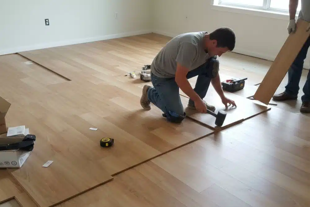Professional Chamblee, GA LVP installation featuring a contractor using a rubber mallet to secure luxury vinyl planks.