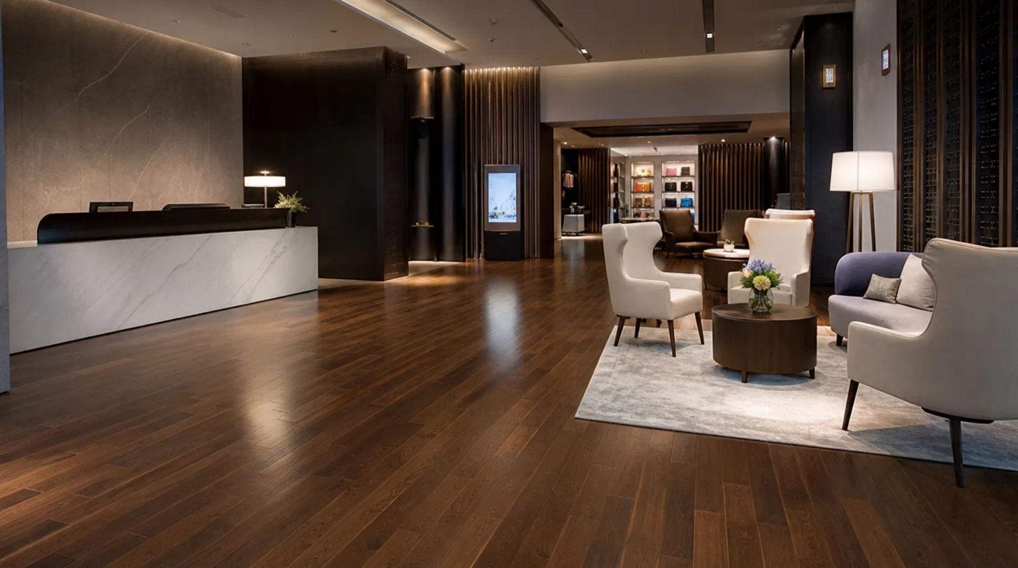 Wide-angle view of newly installed dark hardwood floors in a luxury commercial lobby in Smyrna, GA.